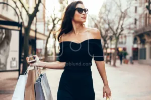 Beautiful female walking on the street with shopping bags